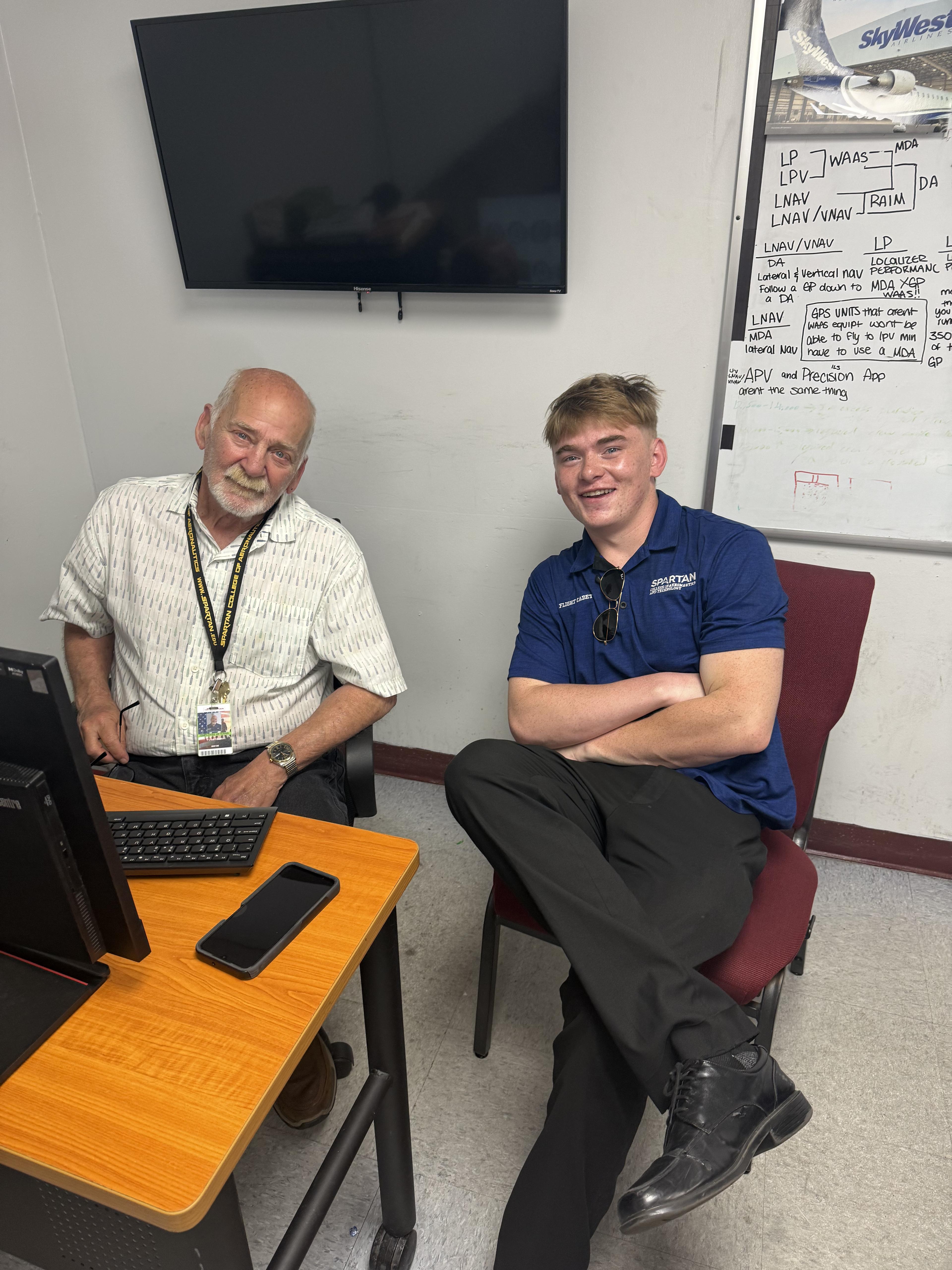 Brandon Wunderlich tutoring a student in ground instruction for private pilot training at Spartan College of Aeronautics